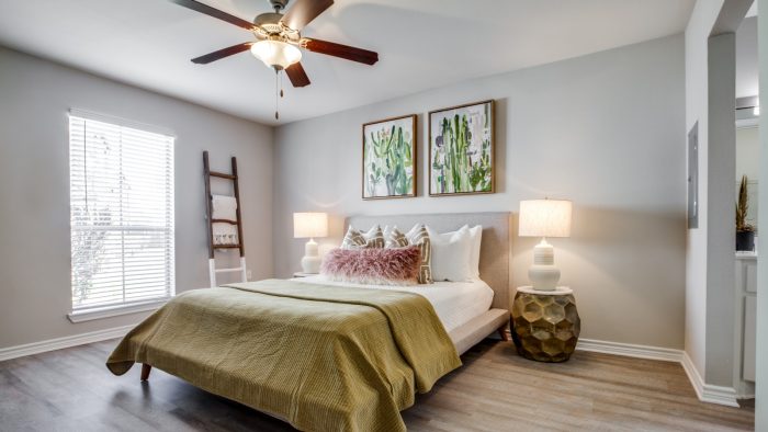 a bedroom with a ceiling fan and hardwood floors at The  Argyle
