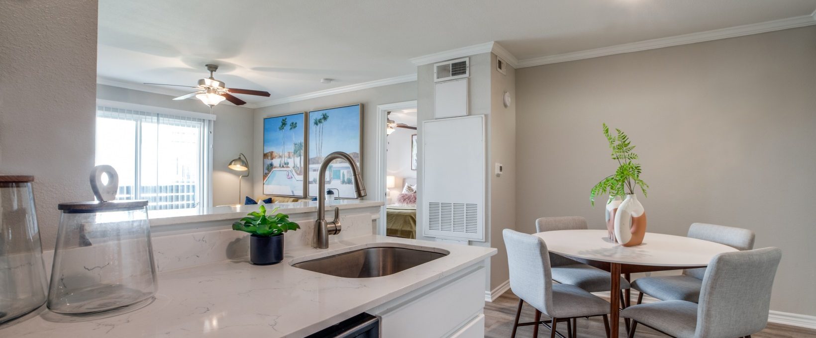 a kitchen with a sink and a dining table at The  Argyle