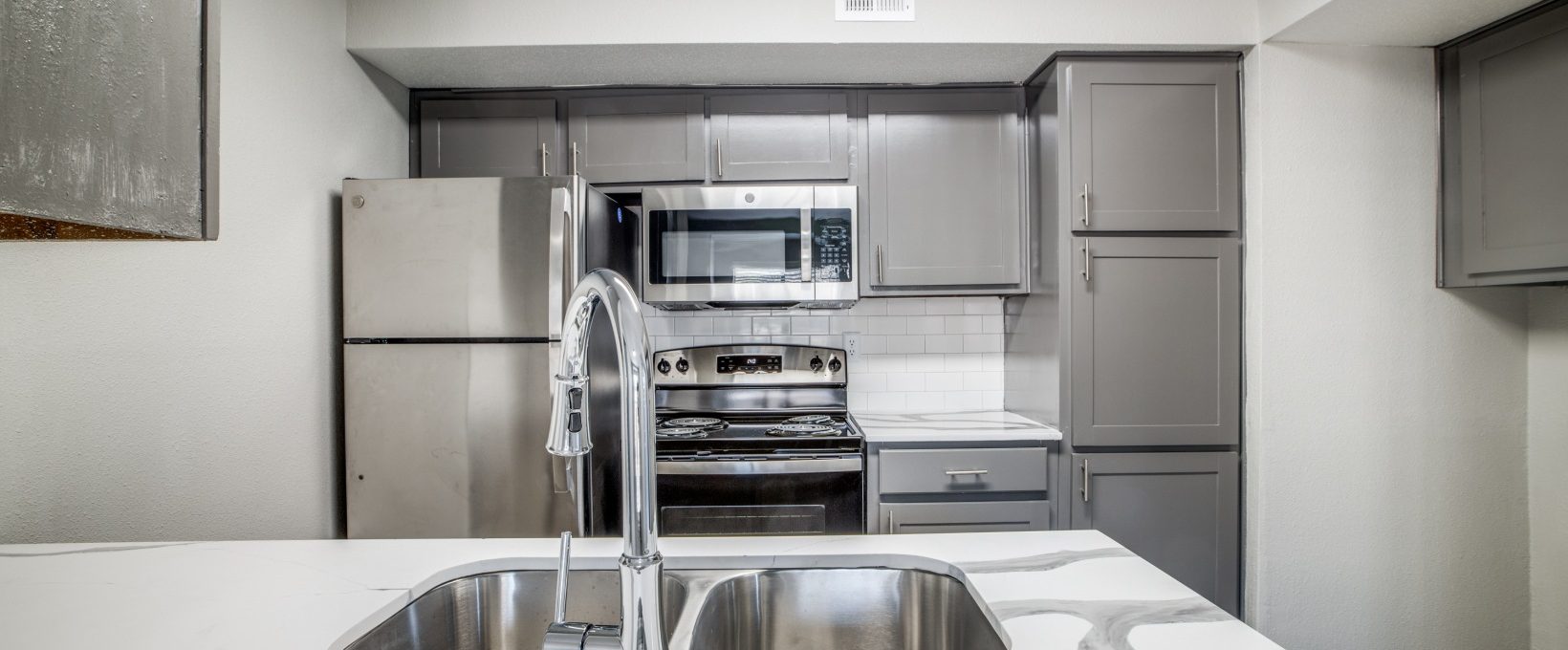 kitchen with stainless steel appliances and granite countertops at The  Argyle