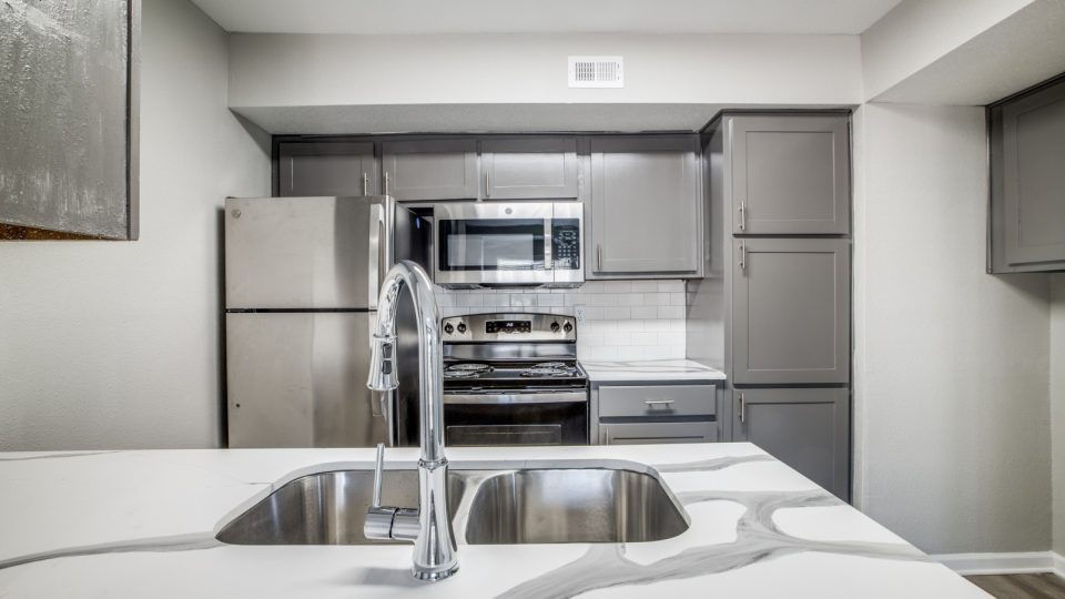 kitchen with stainless steel appliances and granite countertops at The  Argyle