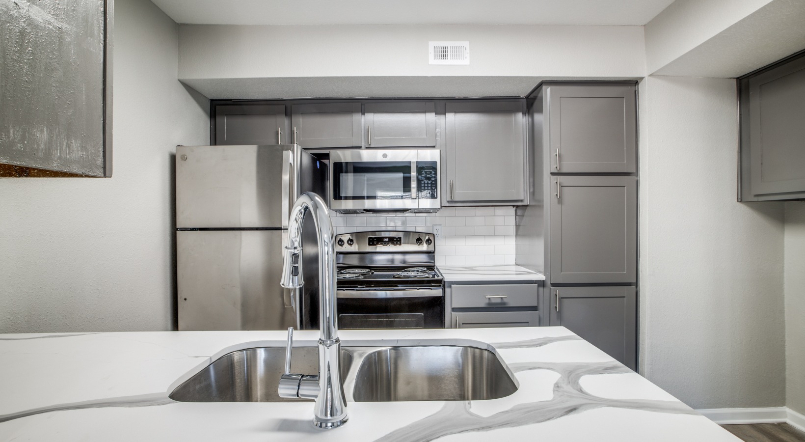 kitchen with stainless steel appliances and granite countertops at The  Argyle
