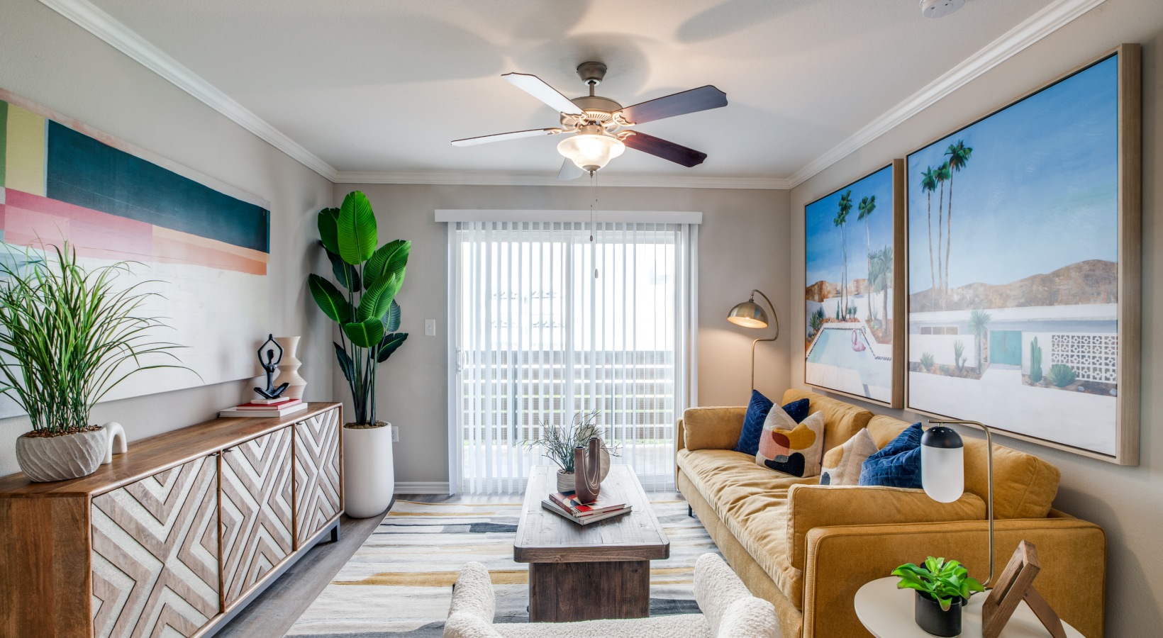 a living room with a ceiling fan and a couch at The  Argyle