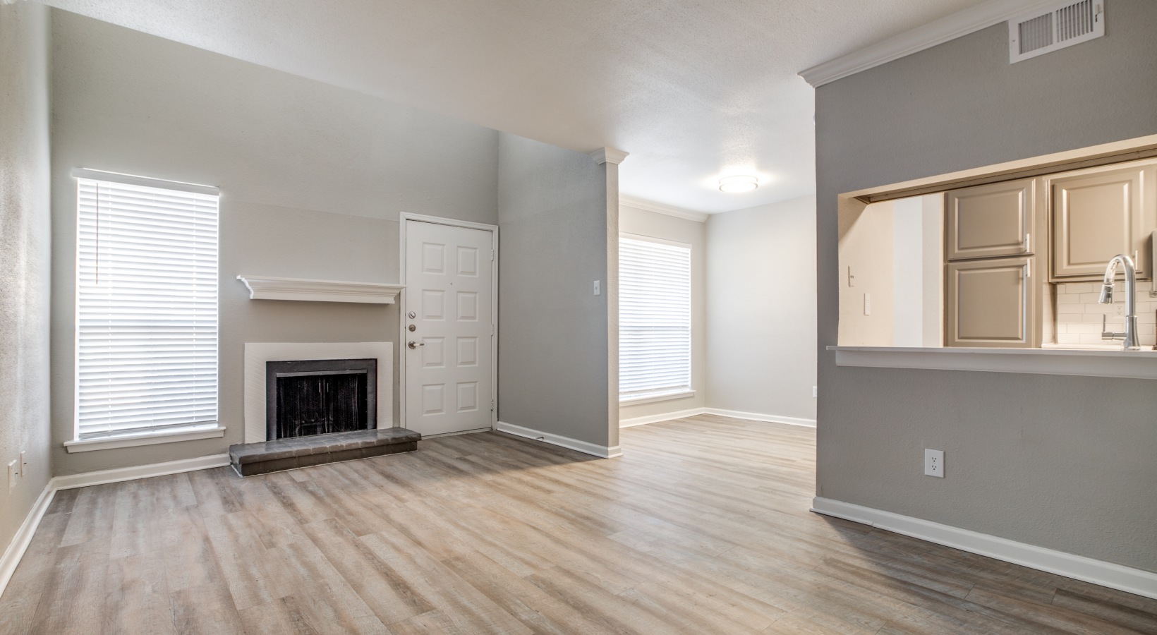 empty living room with hardwood floors and fireplace at The  Argyle