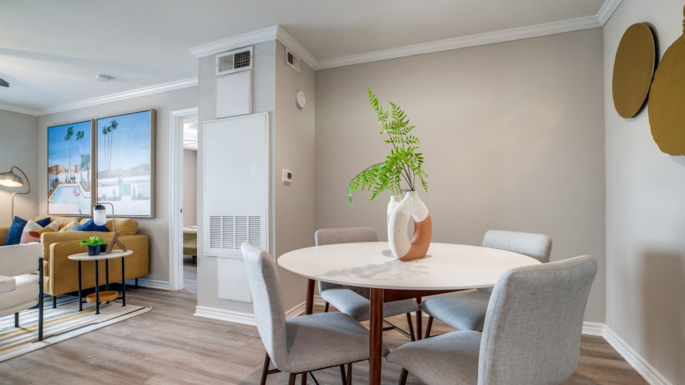a dining room and living room with a table and chairs at The Argyle