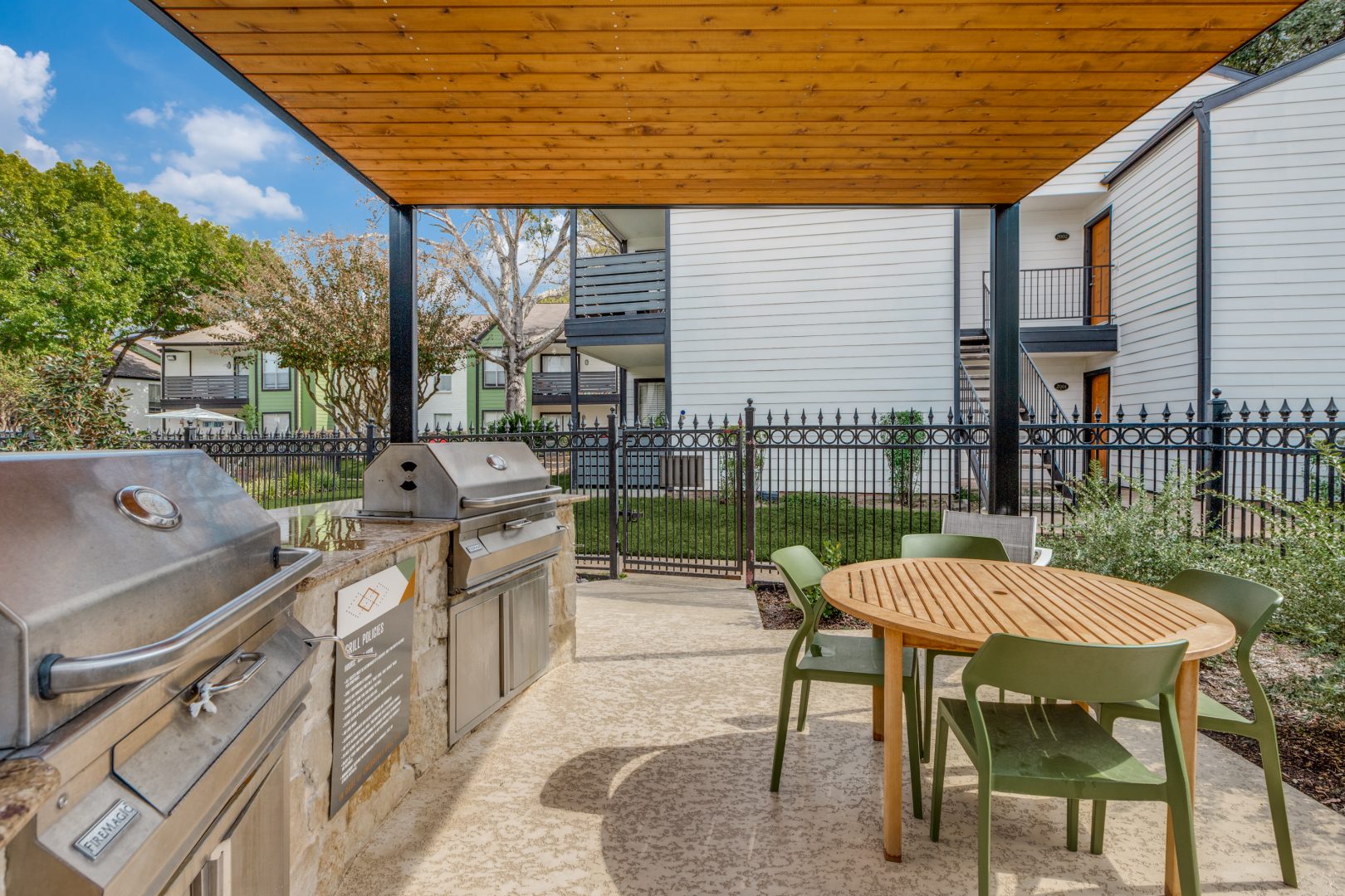 outdoor kitchen with grill and table at The  Argyle