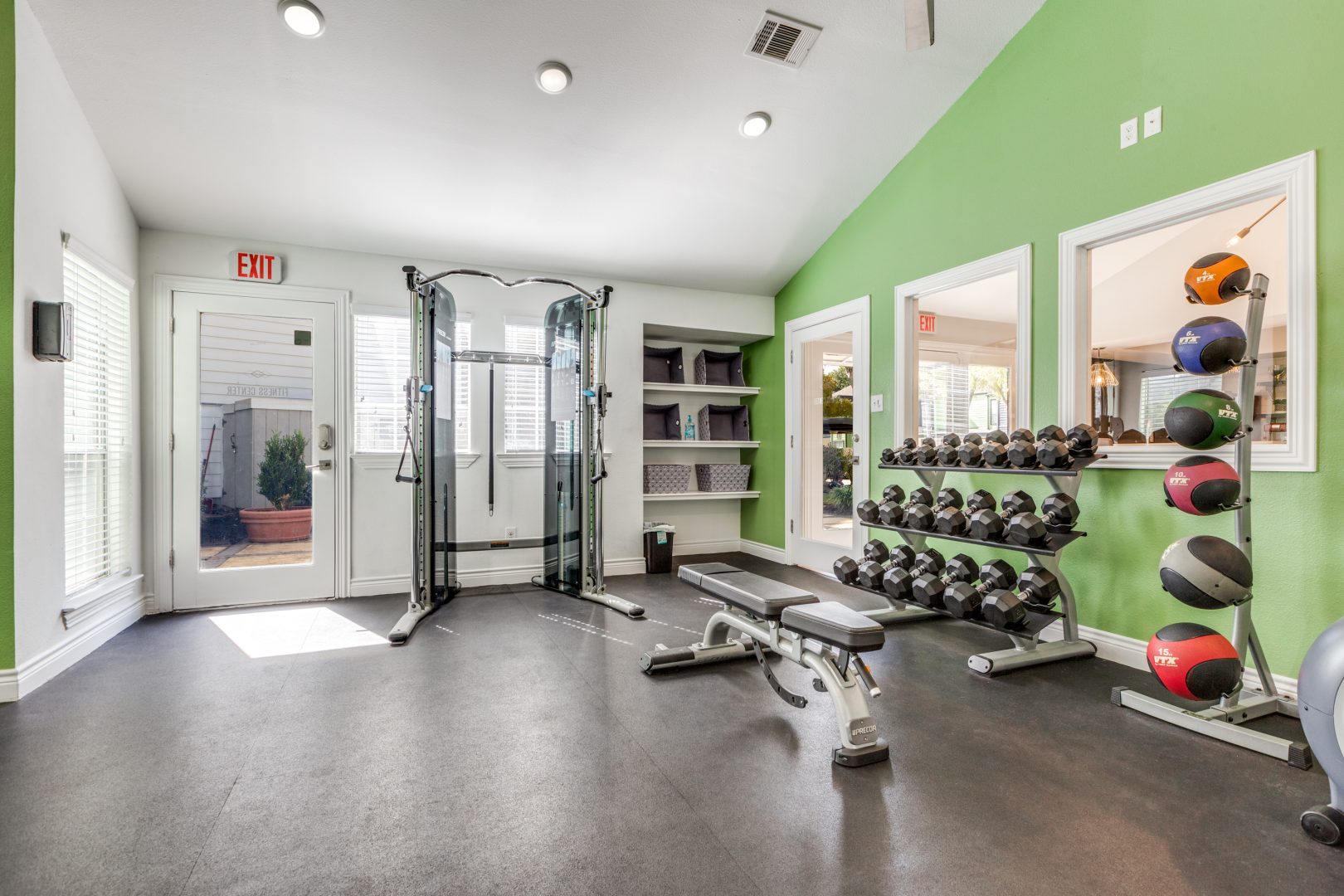 a gym room with a green wall and green floor at The  Argyle