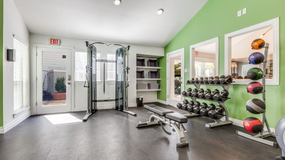 a gym room with a green wall and green floor at The  Argyle